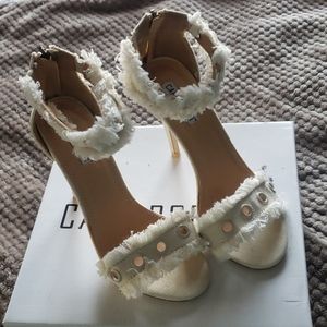 Lightly worn distressed denim heels